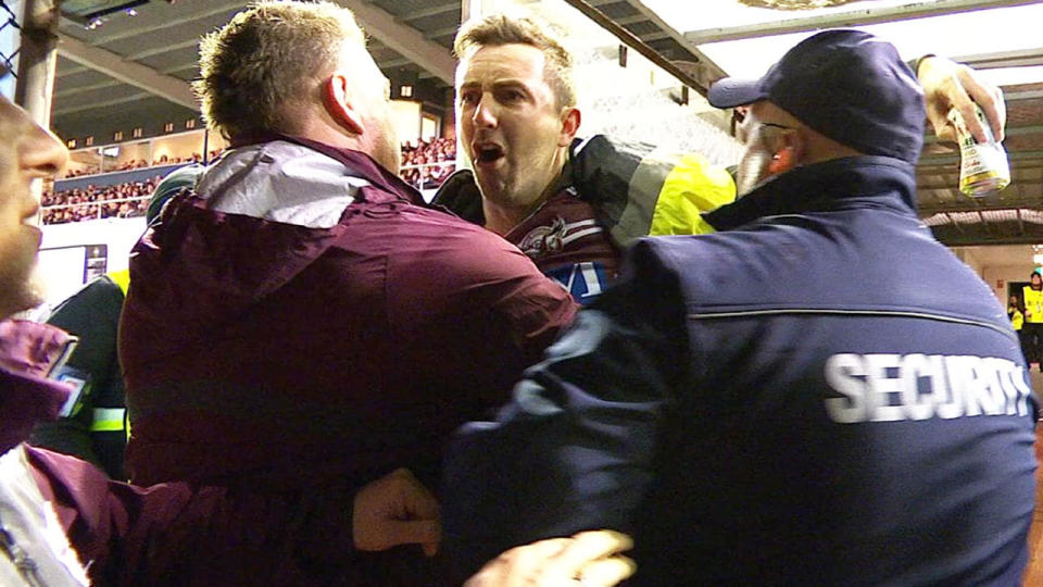 The Manly fan was arrested after clashing with Will Chambers. Image: Fox Sports