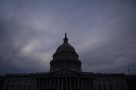 The sun sets behind the U.S. Capitol dome as the Senate continues the impeachment trial of President Trump