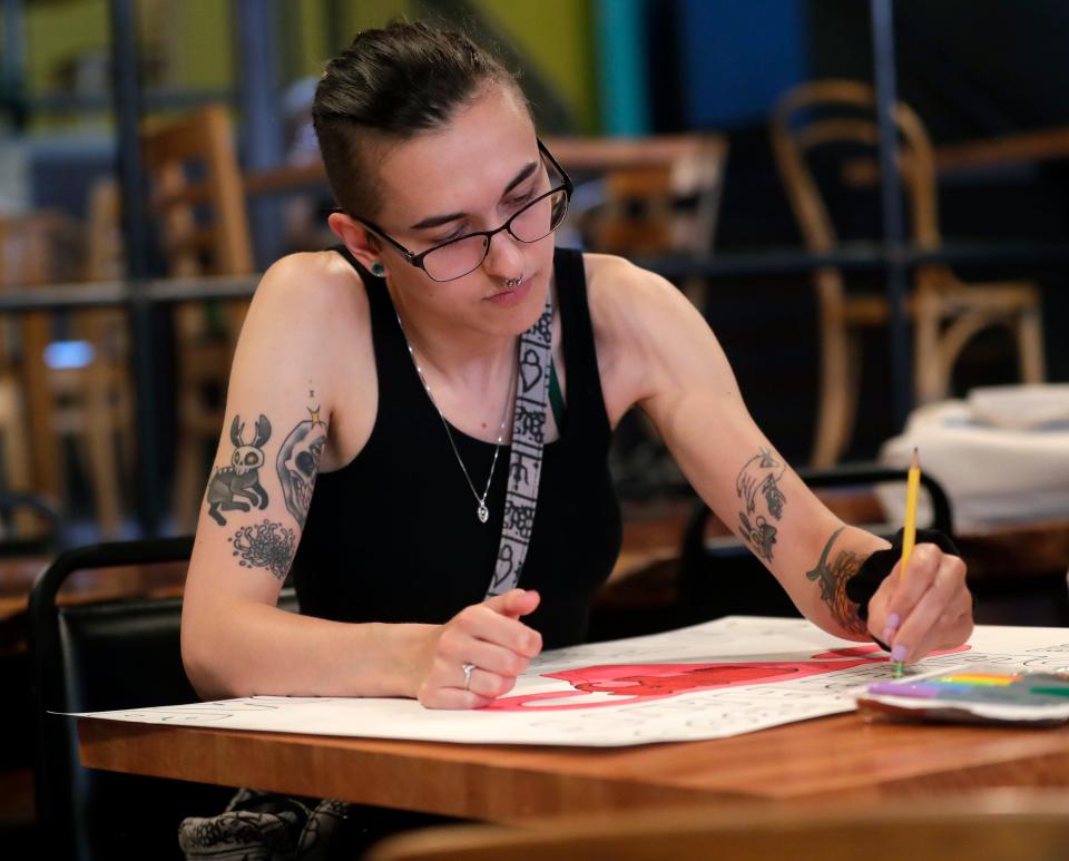 Sam Birkett of Green Bay makes a poster Friday opposing the U.S. Supreme Court's decision to strike down the Roe v. Wade ruling that made abortion legal for the last 50 years.