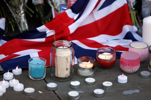 Flowers and candles are seen after a vigil in Albert Square, Manchester. Source: AP