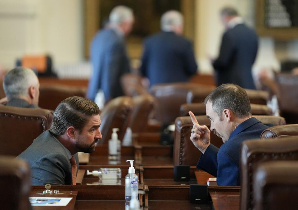 Rep. Jeff Leach, R-Plano, left, talks with Rep. Andrew Murr, R-Junction, in the House on Tuesday.