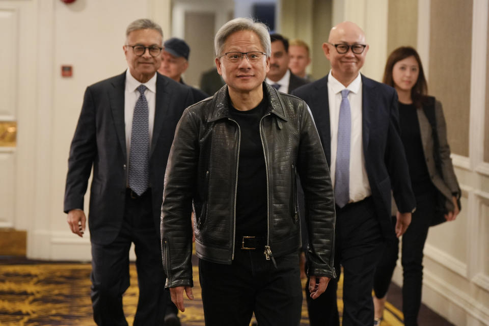 Nvidia CEO and co-founder Jensen Huang, center, arrives for a media round table event at a hotel in Kuala Lumpur, Malaysia Friday, Dec. 8, 2023. (AP Photo/Vincent Thian)