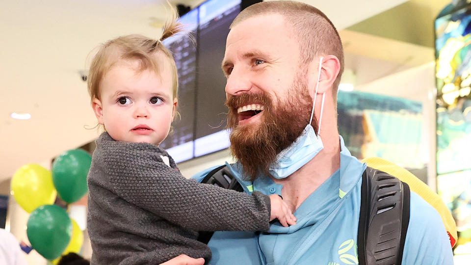 Socceroos goalkeeper Andrew Redmayne was reunited with his daughter when the team touched down in Australia on Wednesday. (Photo by Matt King/Getty Images)