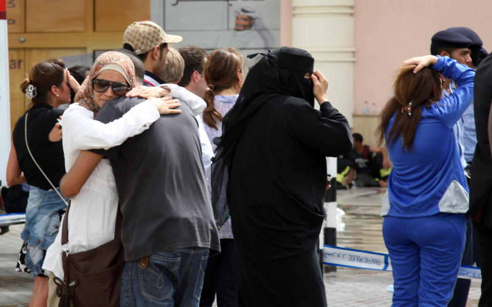 Family members of victims of a fire react in grief after a fire took hold of the Villaggio Mall, in Doha's west end, in the Qatari capital of Doha Monday May 28, 2012. Qatar's Interior Ministry said 13 children were among 19 people killed in a fire that broke out at one of the Gulf state's fanciest shopping mall on Monday. The Villaggio opened in 2006 and is one of Qatar's most popular shopping and amusement destinations. It includes an ice skating rink and indoor Venice-style gondola rides. (AP Photo/Osama Faisal)