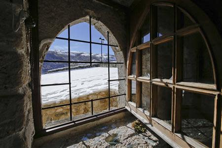 A broken window is seen in the small mountain church of San Pietro della Ienca, near the city of L'Aquila January 28, 2014. Thieves broke into a small church in the mountains east of Rome over the weekend and stole the reliquary with the blood of the late Pope John Paul II, a custodian said on Monday. REUTERS/Max Rossi