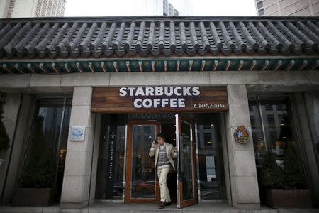A man walks out of a Starbucks coffee shop in Seoul, South Korea, March 7, 2016. Picture taken March 7, 2016. REUTERS/Kim Hong-Ji