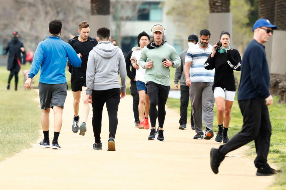 People enjoy their one hour of exercise allowed under stage 4 restrictions at Albert Park.