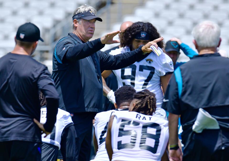 Jaguars coach Doug Pederson talks to players and coaches after minicamp practice on June 14.