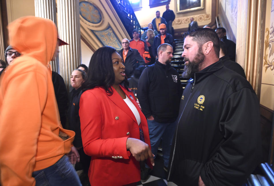 Senator Sarah Anthony, left, talks with Chad Fabbro, of Vassar, outside Senate chambers, Tuesday morning, March 14, 2023. Fabbro is the financial secretary of UAW Local 598 out of Flint. A Michigan Senate committee voted Tuesday morning to advance bills that would represent landmark victories for labor unions by repealing the 2012 right-to-work law and re-establishing a prevailing wage standard for state projects. (Todd McInturf/Detroit News via AP)