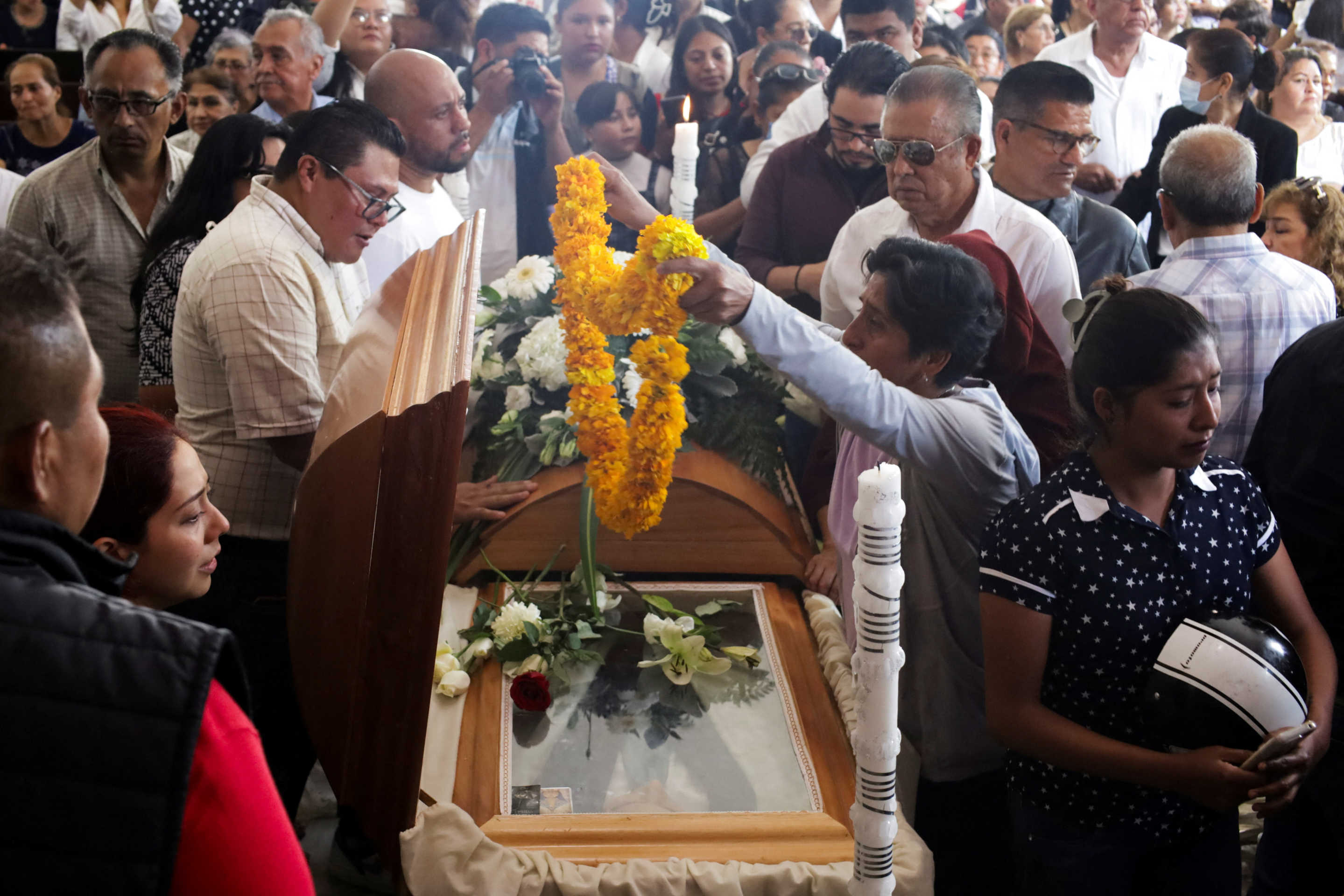 Mourners pay their respects at the casket during the funeral service for Alejandro Arcos, the mayor of Chilpancingo who was killed on Sunday less than a week after taking office, as Mexico's President Claudia Sheinbaum is set to unveil a new security policy, in Chilpancingo, Mexico October 7, 2024. REUTERS/Oscar Ramirez