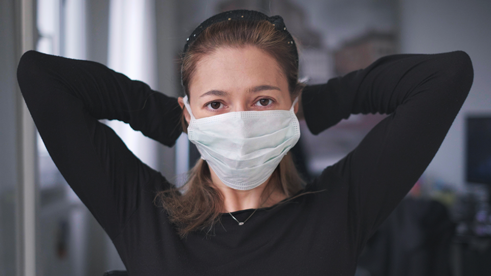 Young woman coronavirus mask mental health impact