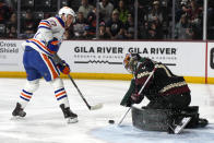 Arizona Coyotes goaltender Karel Vejmelka (70) makes a save against Edmonton Oilers center Connor McDavid in the first period during an NHL hockey game, Monday, March 27, 2023, in Tempe, Ariz. (AP Photo/Rick Scuteri)