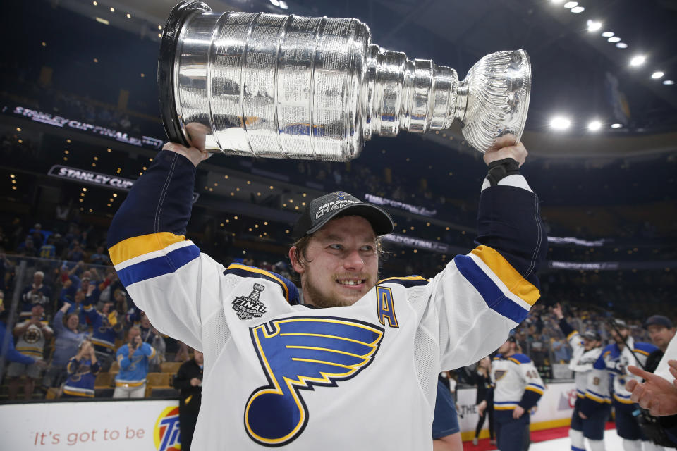 FILE - In this June 12, 2019, file photo, St. Louis Blues' Vladimir Tarasenko, of Russia, carries the Stanley Cup after the team defeated the Boston Bruins in Game 7 of the NHL Stanley Cup Final in Boston. Tarasenko is thankful for the internet because it allows his grandfather back home in Russia to watch NHL games. Starting this season, Tarasenko’s grandfather and the rest of Russia will be able to watch every single regular-season and playoff game. The NHL is expanding its reach into Russia with a new streaming agreement with Yandex that will more than triple the amount of games broadcast there. (AP Photo/Michael Dwyer, File)