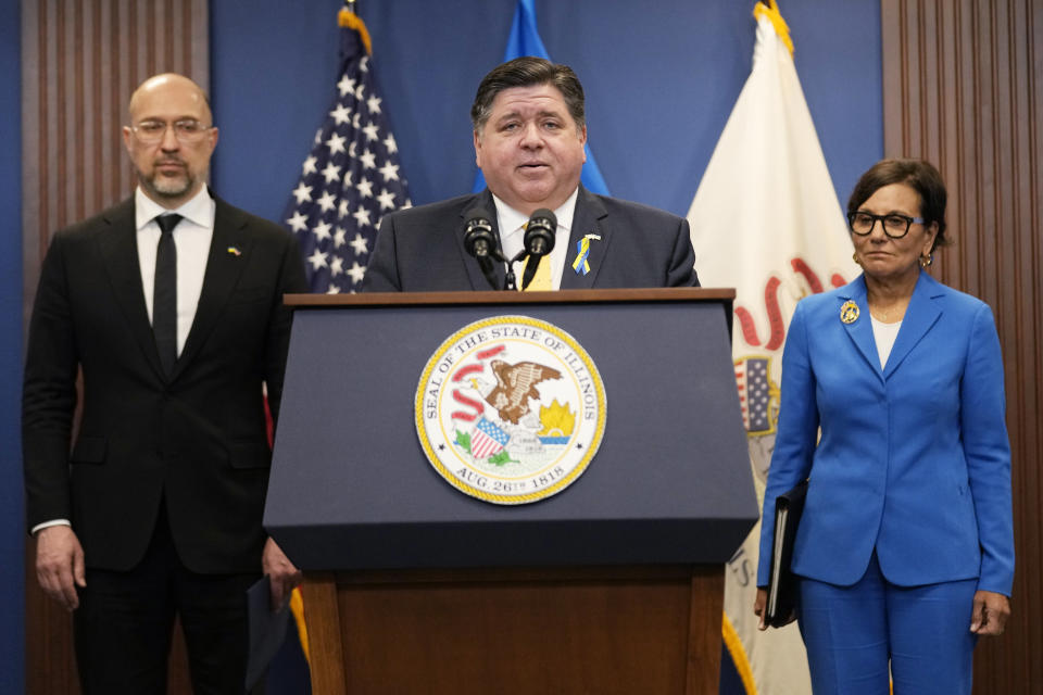 Illinois Gov. J.B. Pritzker, center, speaks as Ukrainian Prime Minister Denys Shmyhal, left, and U.S. Special Representative for Ukraine's Economic Recovery Penny Pritzker listen at a news conference in Chicago, Tuesday, April 16, 2024. They delivered joint remarks recognizing the Illinois-Ukraine partnership. (AP Photo/Nam Y. Huh)