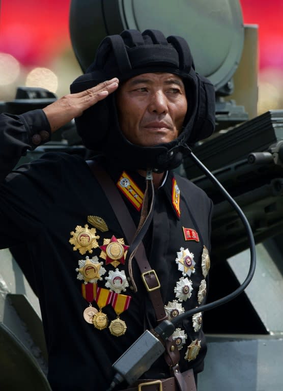 A North Korean soldier saluting from a tank during a military parade past Kim Il-Sung Square in 2013