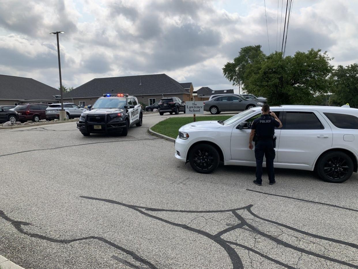 The Waukesha Police Department directs parents who filed in to pick up their children from the Lawrence School on Saylesville Road on Sept. 14 as the school was being closed down. Authorities had been investigating a complaint of child abuse at the daycare center. Three workers have been charged.