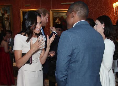 Britain's Prince Harry and Meghan, the Duchess of Sussex meet group of Queen's Young Leaders at a Buckingham Palace reception following the final Queen's Young Leaders Awards Ceremony, in London, June 26, 2018. Yui Mok/Pool via Reuters