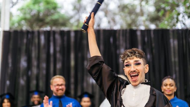 A stock photo from Getty of a nonbinary student graduating. (Photo: Igor Alecsander via Getty Images)