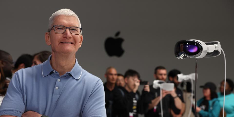 Apple CEO Tim Cook stands next to the new Apple Vision Pro headset is displayed during the Apple Worldwide Developers Conference on June 05, 2023 in Cupertino, California. Apple CEO Tim Cook kicked off the annual WWDC23 developer conference with the announcement of the new Apple Vision Pro mixed reality headset.