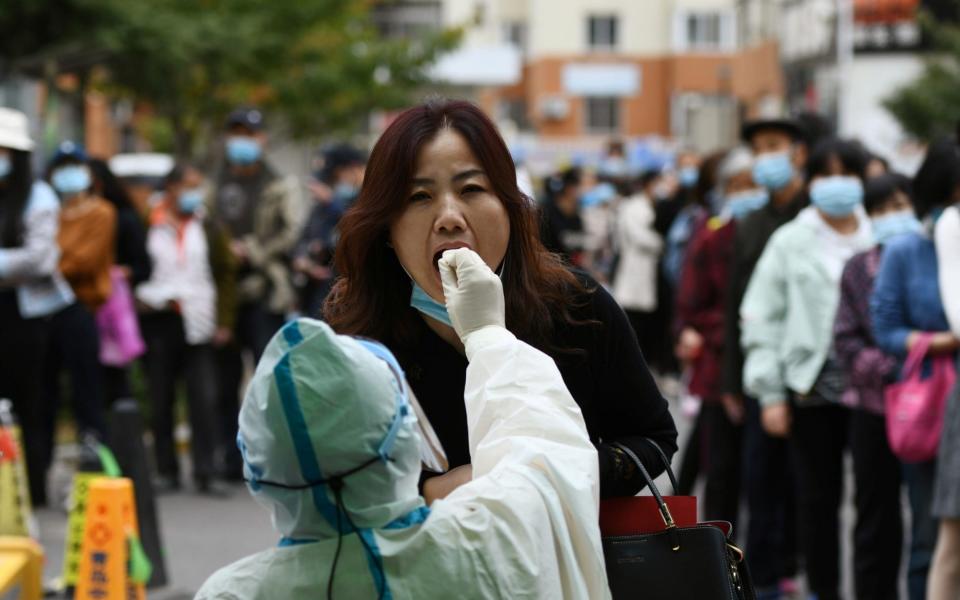 A woman in Qingdao takes a Covid test last week