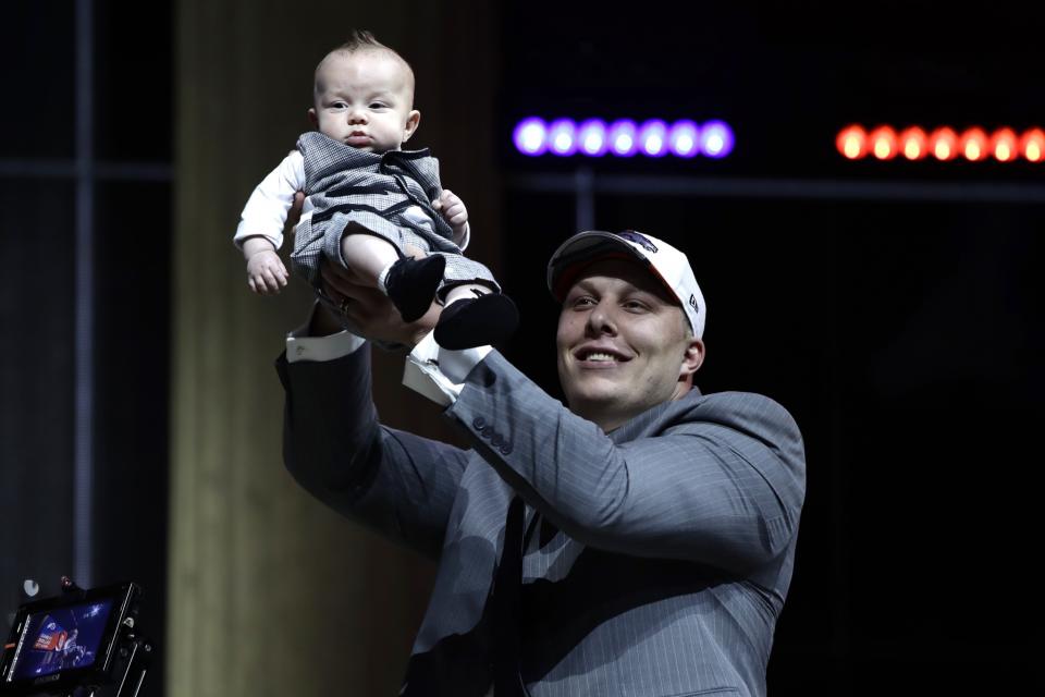 Proud pop: Garett Bolles and his infant son, Kingston. (AP)
