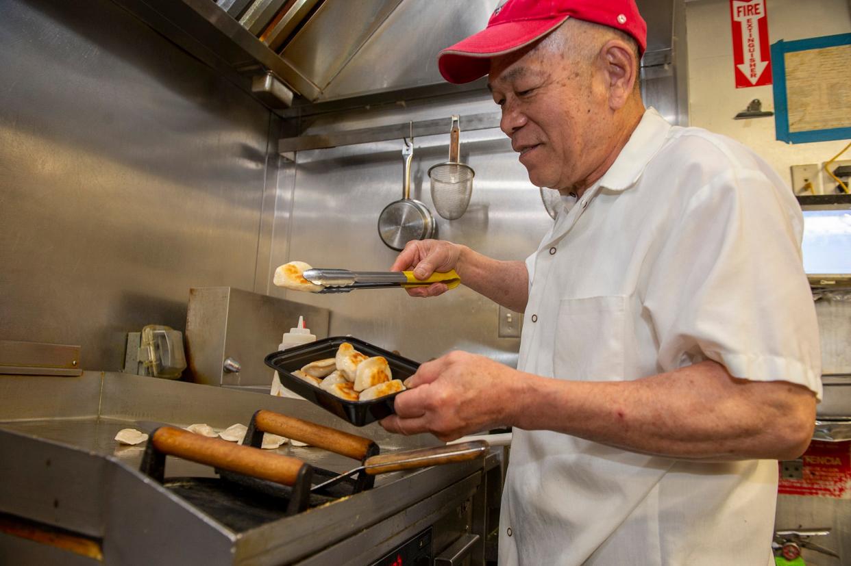 Kun Shan Lee, chef at Dumpling Daughter in Weston, is at work inside the restaurant's kitchen, May 7, 2024.