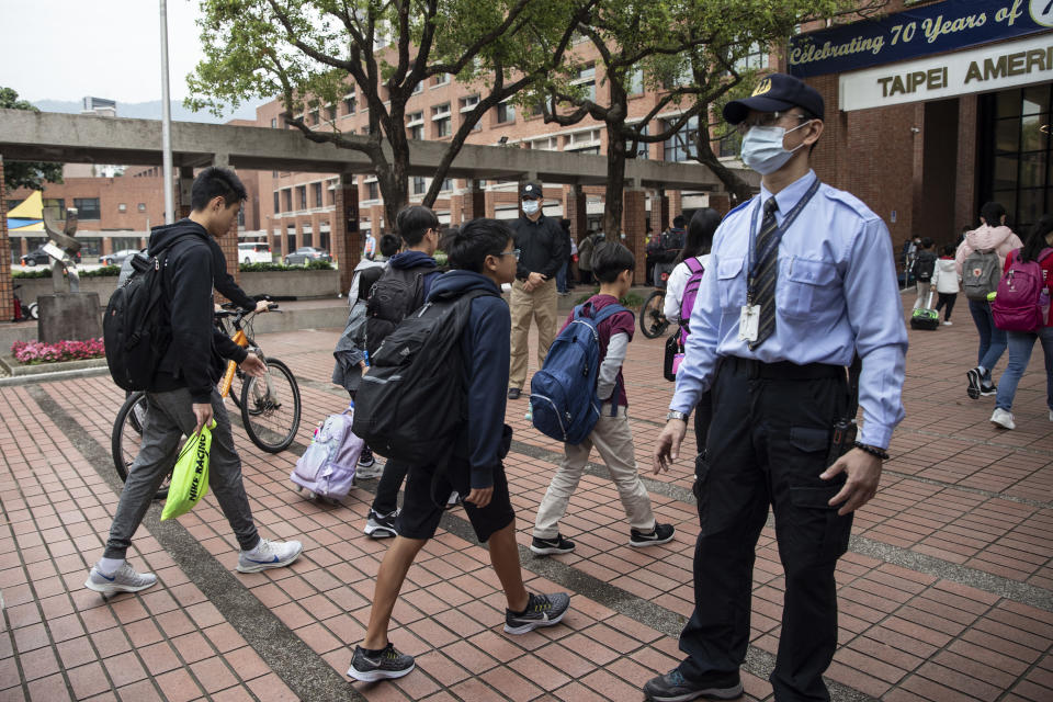 TAIPEI - MARCH 18 : Taiwanese students enter the Taipei American school on March 18, 2020 in Taipei, Taiwan. Taiwan, Singapore and Hong Kong have had more successful approaches in battling the pandemic given their experience with SARS in 2003. According to CDC current totals the Coronavirus ( COVID-19) has now affected 235,939 globally, killing 9,874. It has spread to 157 countries.  (Photo by Paula Bronstein/Getty Images )