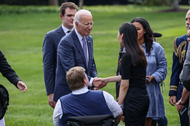 President Joe Biden speaks with guests Monday at a reception for the Americans with Disabilities Act on the South Lawn at the White House. Photo by Jemal Countess/UPI