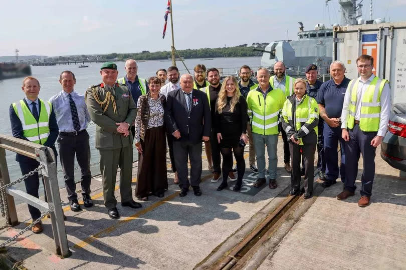 The Naval Base Commander of HMNB Devonport, Brigadier Mike Tanner ADC OBE RM and team members of the dockyard with Dave Trigger MBE and his wife