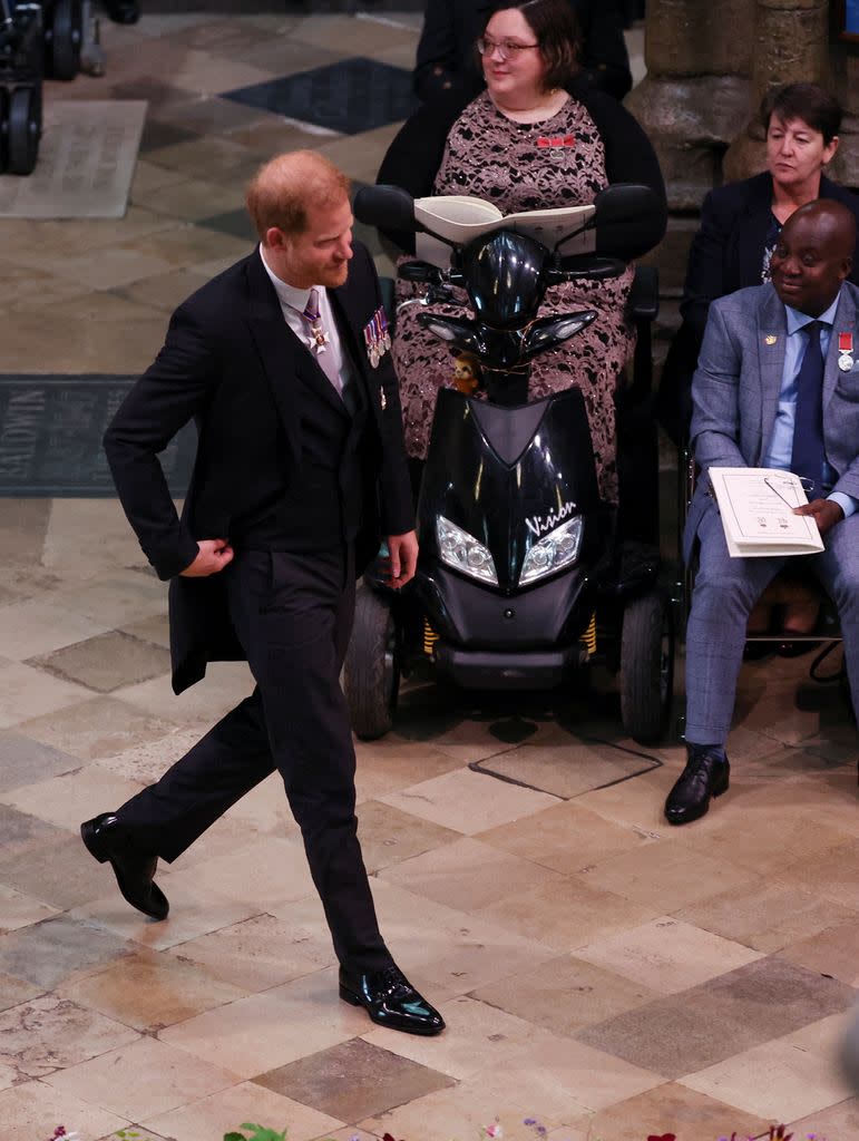 Prince Harry walking to his seat at the coronation