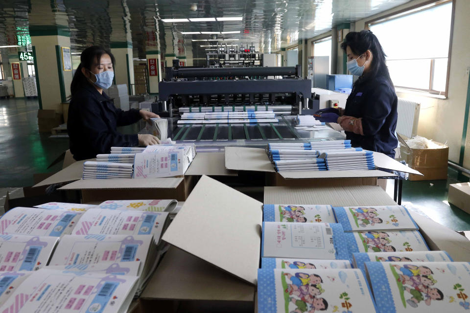 Employees at the Mindulle Notebook Factory assemble notebooks in a larger quantity to pupils and students across the country in Pyongyang, North Korea, Thursday, Nov. 12, 2020. North Korea is staging an “80-day battle,” a propaganda-heavy productivity campaign meant to bolster its internal unity and report greater production in various industry sectors ahead of a ruling party congress in January. (AP Photo/Jon Chol Jin)