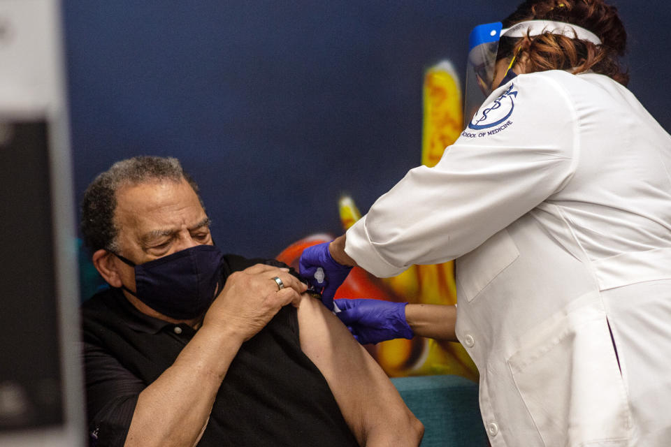 Andrew Young, former U.S. Ambassador to the United Nations receives his COVID-19 vaccination on Tuesday, Jan. 5, 2021, at the Morehouse School of Medicine in Atlanta. Young, baseball great Hank Aaron and others received their vaccinations in an effort to highlight the importance of getting vaccinated for Black Americans who might be hesitant to do so. (AP Photo/Ron Harris)