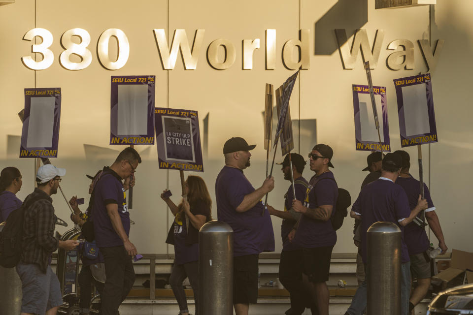 Los Angeles city employees with SEIU Local 721 join a picket line at the Los Angeles International Airport in Los Angeles on Tuesday, Aug. 8, 2023. Thousands of Los Angeles city employees, including sanitation workers, engineers and traffic officers, walked off the job for a 24-hour strike alleging unfair labor practices. The union said its members voted to authorize the walkout because the city has failed to bargain in good faith and also engaged in labor practices that restricted employee and union rights. (AP Photo/Damian Dovarganes)