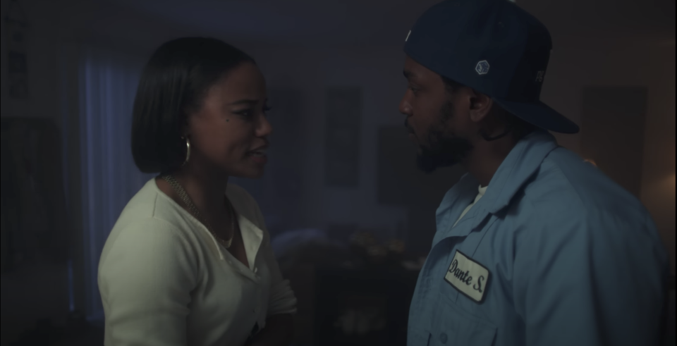 Taylour Paige in white shirt arguing with Kendrick Lamar in blue shirt and black hat in 'We Cry Together' short film.