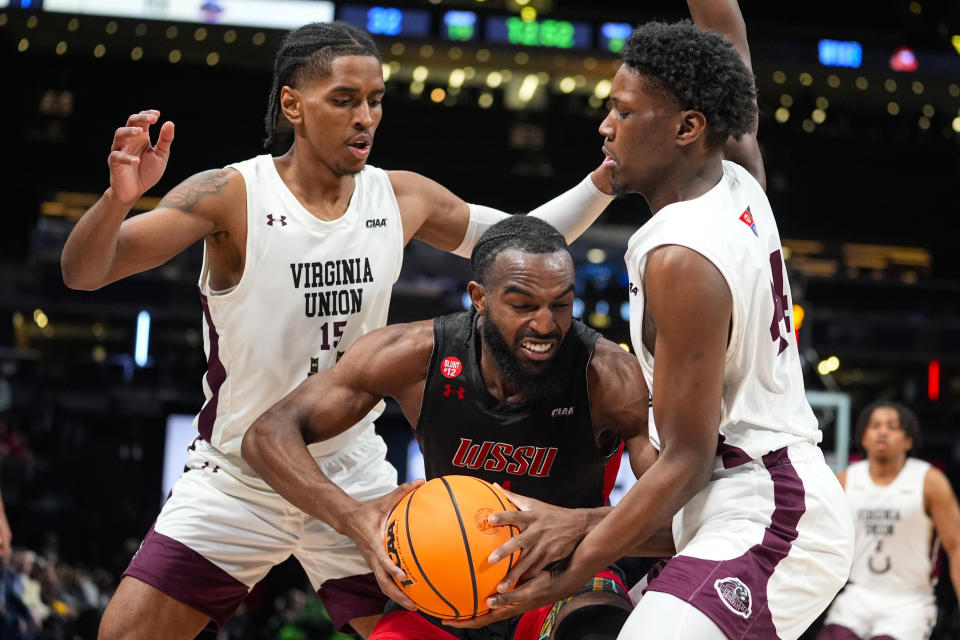 Winston-Salem State guard Jaylen Alston (4) is trapped by Virginia Union forwards Jonathan King (15) and Joshua Caine (44) during the second half of the HBCU Classic NCAA college basketball game in Indianapolis, Saturday, Feb. 17, 2024. (AP Photo/Michael Conroy)