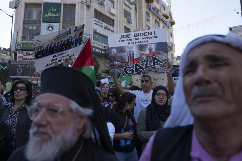 Palestinian demonstrators carry banners and chant anti Israel slogans during a rally in support of the Gaza Strip, in the West Bank city of Ramallah, Friday, Oct. 13, 2023. Tens of thousands of Muslims demonstrated Friday across the Middle East in support of the Palestinians and against the intensifying Israeli bombardment of Gaza, underscoring the risk of a wider regional conflict as Israel prepares for a possible ground invasion. (AP Photo/Nasser Nasser)