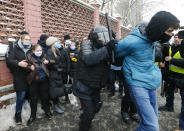 Police officers detain a man during a protest near the Matrosskaya Tishina prison where Alexei Navalny is being held, in Moscow, Russia, on Sunday, Jan. 31, 2021. Chanting slogans against President Vladimir Putin, thousands of people took to the streets Sunday across Russia's vast expanse to demand the release of jailed opposition leader Alexei Navalny, keeping up the nationwide protests that have rattled the Kremlin. Over 1,600 were detained by police, according to a monitoring group. (AP Photo/Alexander Zemlianichenko)