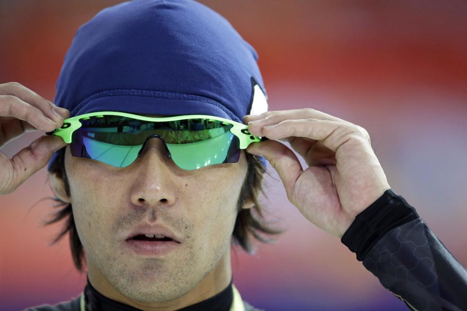 Keiichiro Nagashima of Japan adjusts his glasses as he trains at the Adler Arena Skating Center during the 2014 Winter Olympics in Sochi, Russia, Sunday, Feb. 9, 2014. (AP Photo/Patrick Semansky)