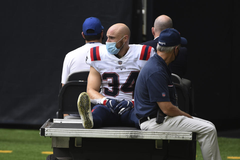 New England Patriots running back Rex Burkhead (34) is taken off the field by cart after an injury during the second half of an NFL football game against the Houston Texans, Sunday, Nov. 22, 2020, in Houston. (AP Photo/Eric Christian Smith)