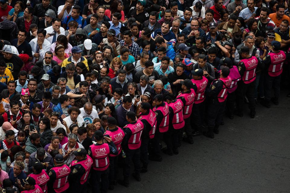 People are seen during the transfer of the remains of Mexican singer Juan Gabriel.