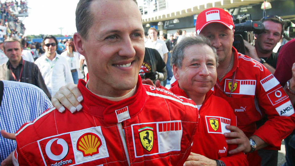 Michael Schumacher walks in the pits with Ferrari general director Jean Todt in 2006. AFP PHOTO ANTONIO SCORZA