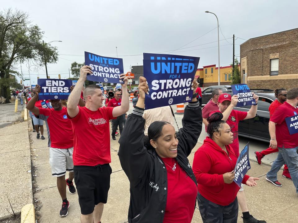 United Auto Workers members march while holding signs at a union rally held near a Stellantis factory Wednesday, Aug. 23, 2023, in Detroit. UAW President Shawn Fain told reporters that bargaining on a new contract is not going well between the UAW and Detroit's three automakers. (AP Photo/Mike Householder)