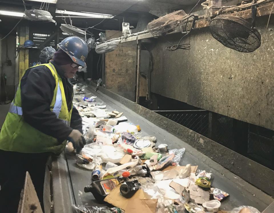 A Casella employee hand-sorts a stream of paper and plastics Thursday at Chittenden Solid Waste District in Williston on Jan. 31, 2019.