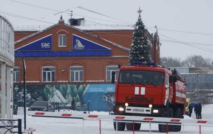 A fire truck drives past the administrative building of the Listvyazhnaya coal mine in Kemerovo region