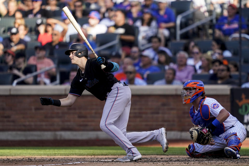 Miami Marlins' Brian Anderson hits an RBI double off New York Mets starting pitcher Carlos Carrasco (59) in the sixth inning of a baseball game, Saturday, July 9, 2022, in New York. (AP Photo/John Minchillo)