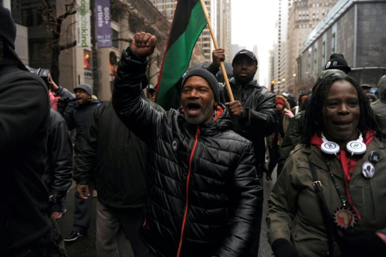 Protesters march on Chicago's Magnificent Mile shopping strip during the Black Friday shopping day on November 27, 2015, demanding justice for a black teen killed by a police officer