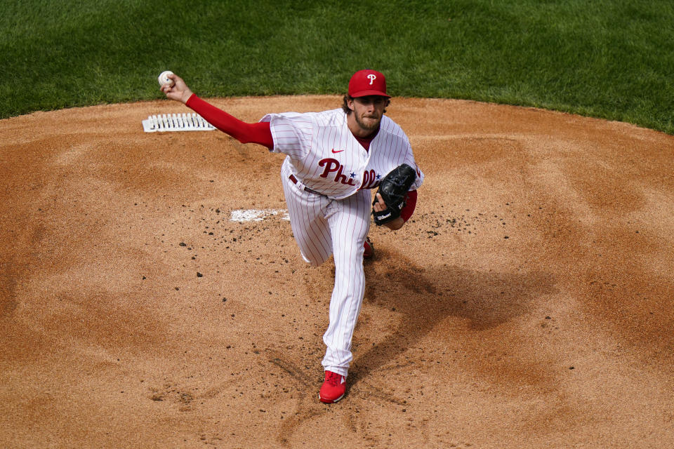 Philadelphia Phillies' Aaron Nola pitches during the first inning of an opening day baseball game against the Atlanta Braves, Thursday, April 1, 2021, in Philadelphia. (AP Photo/Matt Slocum)