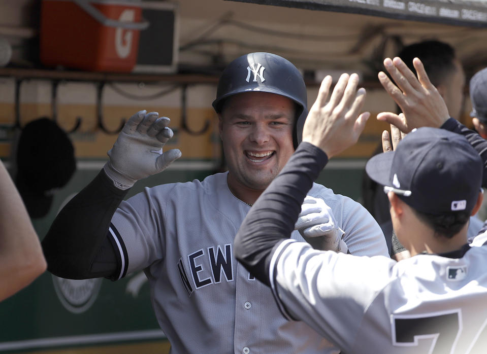 New York Yankees' Luke Voit, center, celebrates with teammates after hitting a two-run home run against the Oakland Athletics during the second inning of a baseball game in Oakland, Calif., Monday, Sept. 3, 2018. (AP Photo/Jeff Chiu)