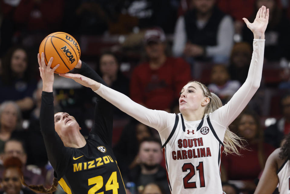 Missouri guard Ashton Judd, left, fights for a rebound against South Carolina forward Chloe Kitts, right, during the first half of an NCAA college basketball game in Columbia, S.C., Thursday, Feb. 8, 2024. (AP Photo/Nell Redmond)