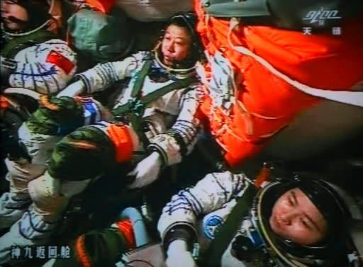 Chinese astronauts Liu Wang (centre), Jing Haipeng (left) and Liu Yang in the Shenzhou-9 spacecraft during a manned space mission which includes China's first female astronaut on June 24. Neil Armstrong's 1969 lunar landing marked a pinnacle of US technological achievement, defining what many saw as the American century, but the next person to set foot on the moon will likely be Chinese